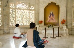 Devotees meditating in Smriti Mandir
