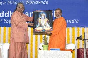 Swami Tejomayananda is presented with the photograph of Yogeshwar Krishna.