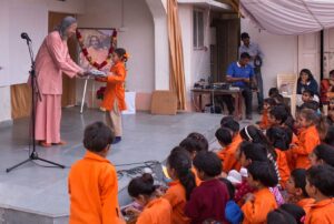 Swami Vasudevananda distributes gifts to all participants.