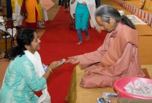 Swami Nirvanananda distributes prasad.