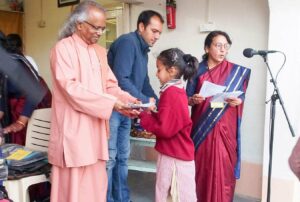 Students receive assessment reports and gifts from Swami Lalitananda.