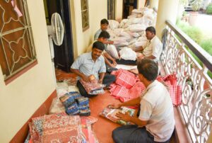 Volunteers help to make parcels for distribution, Dakshineswar.