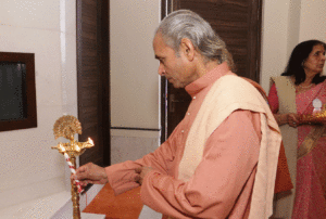 Swami Smaranananda lights the lamp.