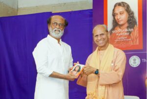 Swami Suddhananda presents the first copy of the Audio Book to Special Guest, Sri Rajinikanth.