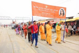 Devotees and monks join in the Prabhat Feri on a misty morning.