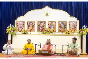 Swami Vasudevananda leads bhajan session.