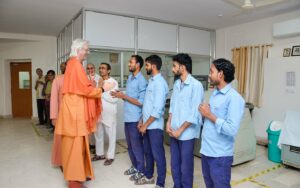 Swamiji greets the devotees and staff at the YSS printing press.