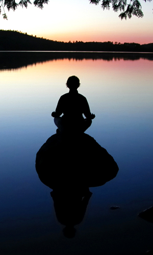 Meditation near a lake — Silhouette
