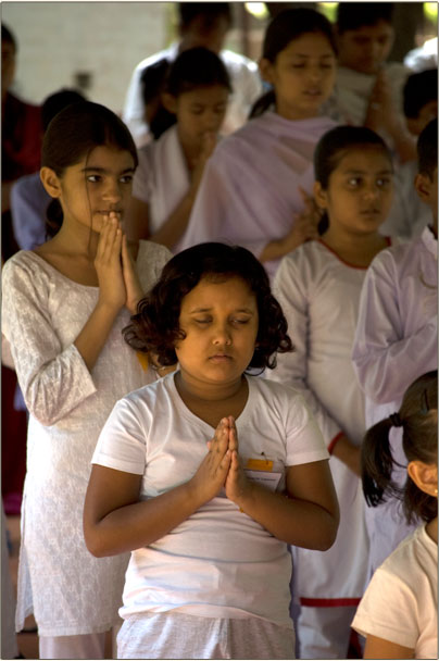 Children praying to God.
