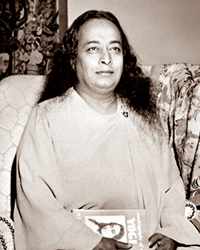 Paramahansa Yogananda holding Autobiography of a yogi
