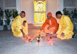 Monastics lighting candles.